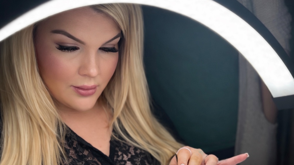 Brandi, master lash artist, seated at her lash station